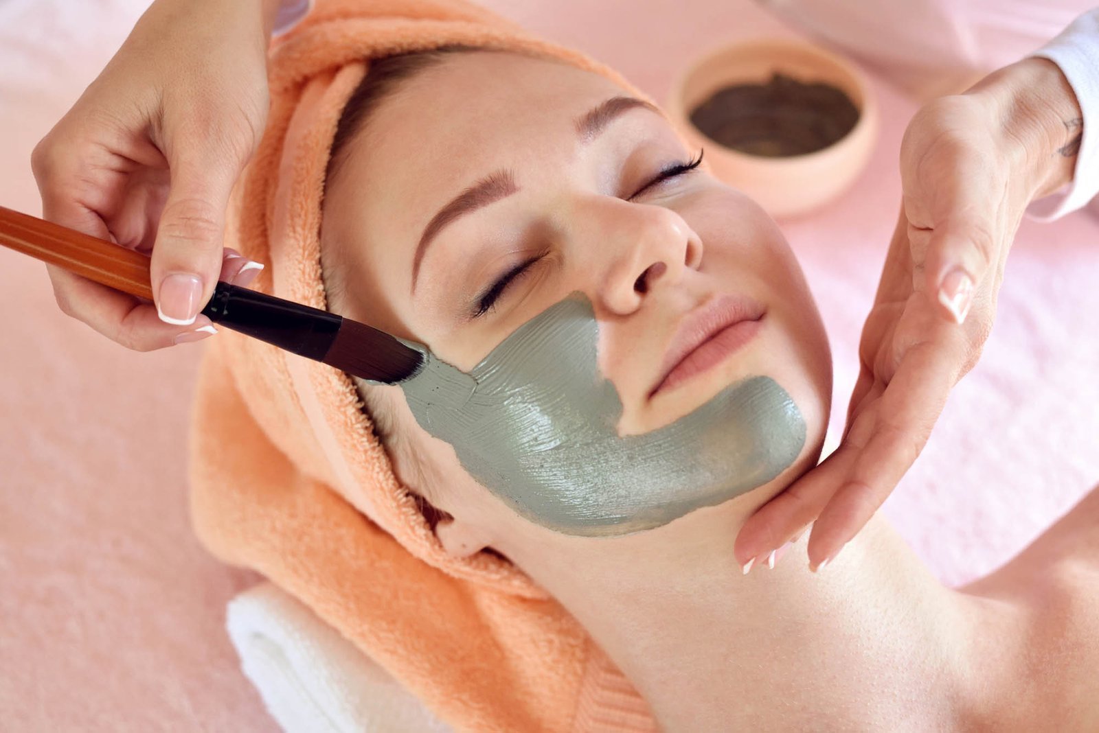 Face peeling mask, spa beauty treatment, skincare. Woman getting Face peeling mask, spa beauty treatment, skincare. Woman getting facial care by beautician at spa salon, side view, close-up
